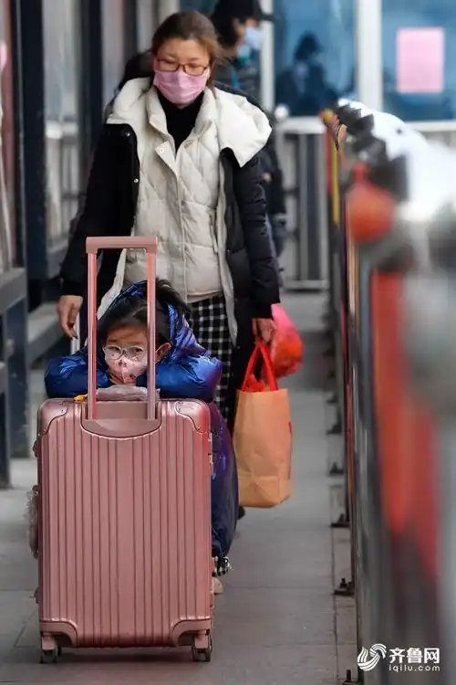 组图新冠肺炎疫情下的济南火车站返程旅客戴口罩沉默前行

